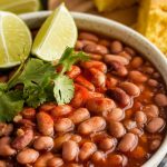 a bowl of perfectly cooked pinto beans with a thick, flavorful broth