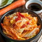 A steaming bowl of spicy crockpot cabbage stir fry served over rice