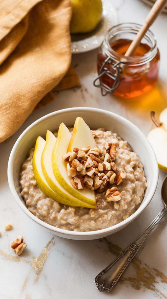 A bowl of freshly served spiced pear oatmeal topped with fresh pear slices