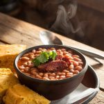 an image of a bowl of pinto beans with smoked meat