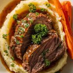 a plated dish with beer-braised short ribs served over creamy mashed potatoes