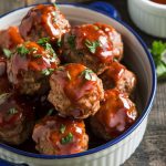 a serving dish filled with glazed honey BBQ meatballs