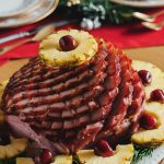 A spiral ham resting on a white platter