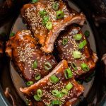 Short ribs in the crockpot fully coated in a glossy honey garlic glaze