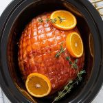 a fully cooked honey-glazed ham in a slow cooker