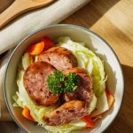 a bowl of Crockpot sausage and cabbage ready to serve