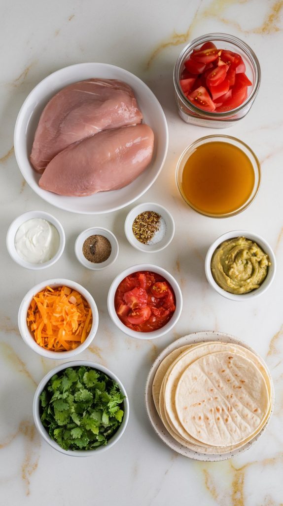 all ingredients for crockpot chicken tacos laid out on white marble counters with hints of gold