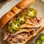 shredded Mississippi Chicken served inside a toasted sandwich bun