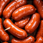 finished little smokies coated in thick glossy glaze, ready to serve with toothpicks in the crockpot