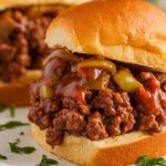 sloppy joes served on golden brown, toasted round hamburger buns, filled with saucy, juicy ground beef mixture