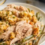 a generous serving of Crockpot Chicken Stuffing Green Beans on a white ceramic plate